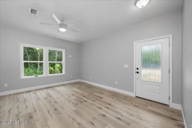wooden floor in an empty room with a window