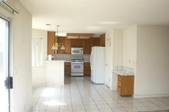 a kitchen with a refrigerator a sink and cabinets