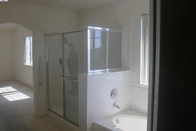 a bathroom with a shower and toilet