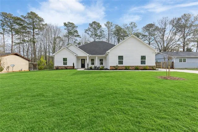 a front view of house with yard and green space
