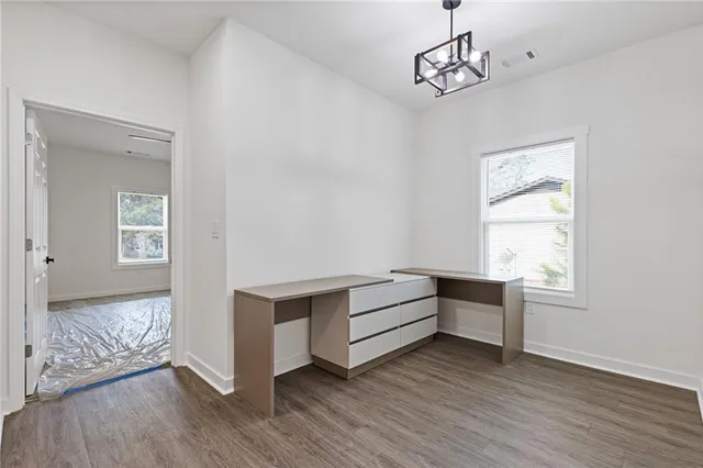a view of room with window and wooden floor