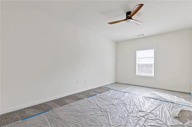 a view of a room with a window and a ceiling fan