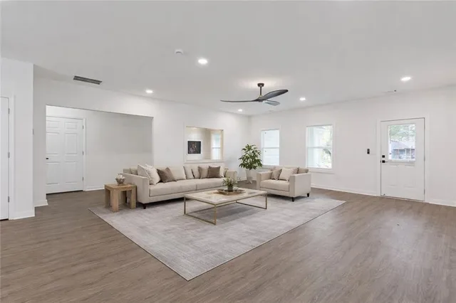 a living room with furniture and wooden floor