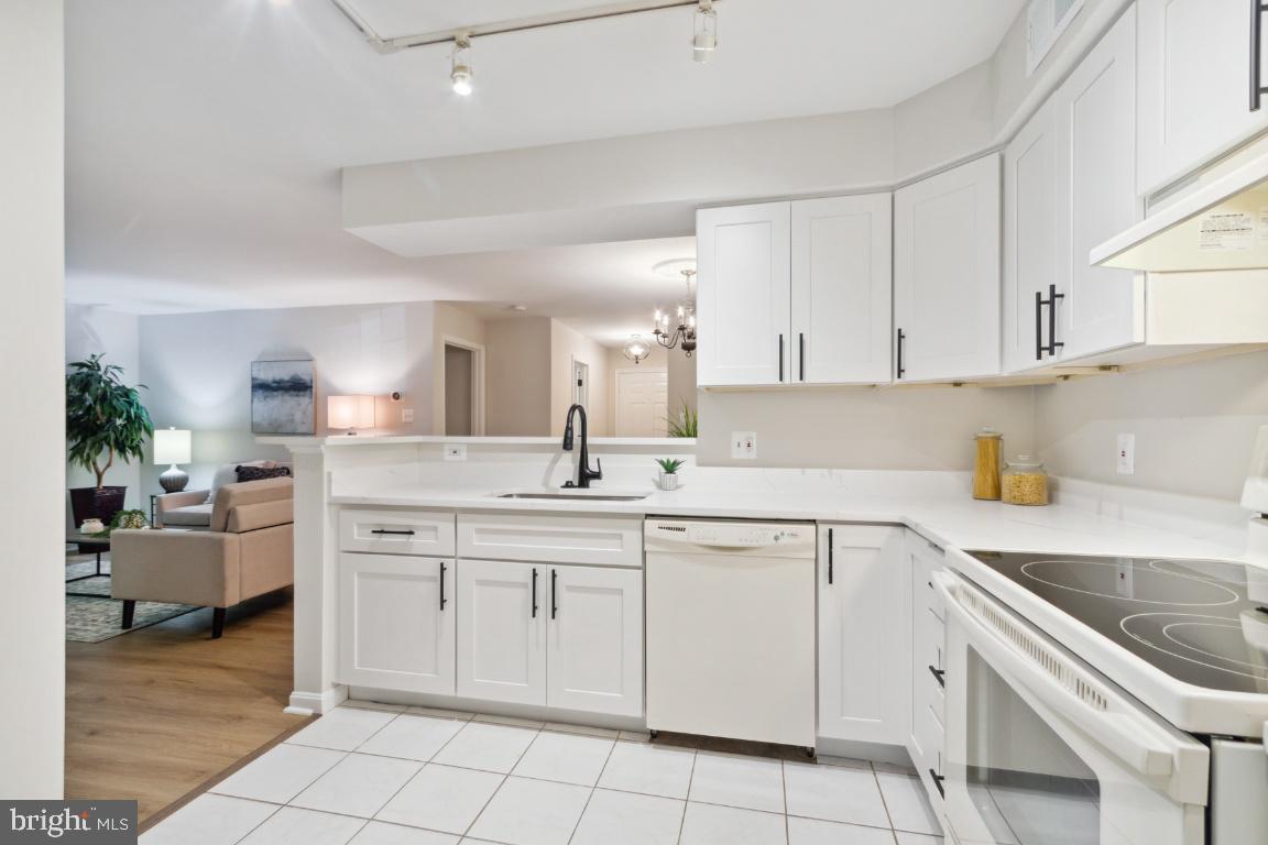 2241 Lovedale Lane, Unit D Reston, VA 20191 - Photo 13 of 31 a kitchen with white cabinets appliances and a sink