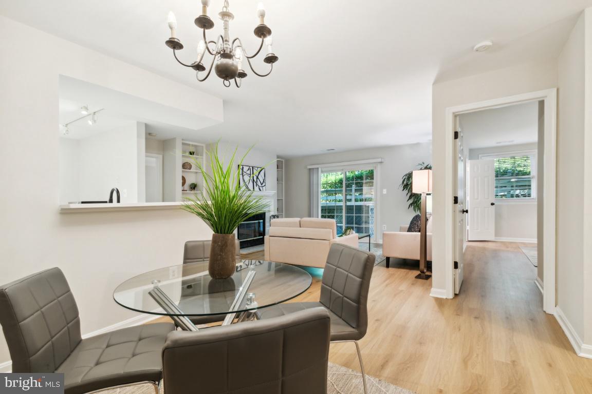 2241 Lovedale Lane, Unit D Reston, VA 20191 - Photo 15 of 31 a view of a dining room with furniture a chandelier and wooden floor
