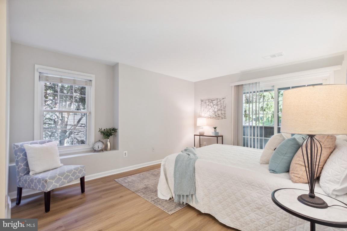 2241 Lovedale Lane, Unit D Reston, VA 20191 - Photo 21 of 31 a bedroom with a bed and wooden floor