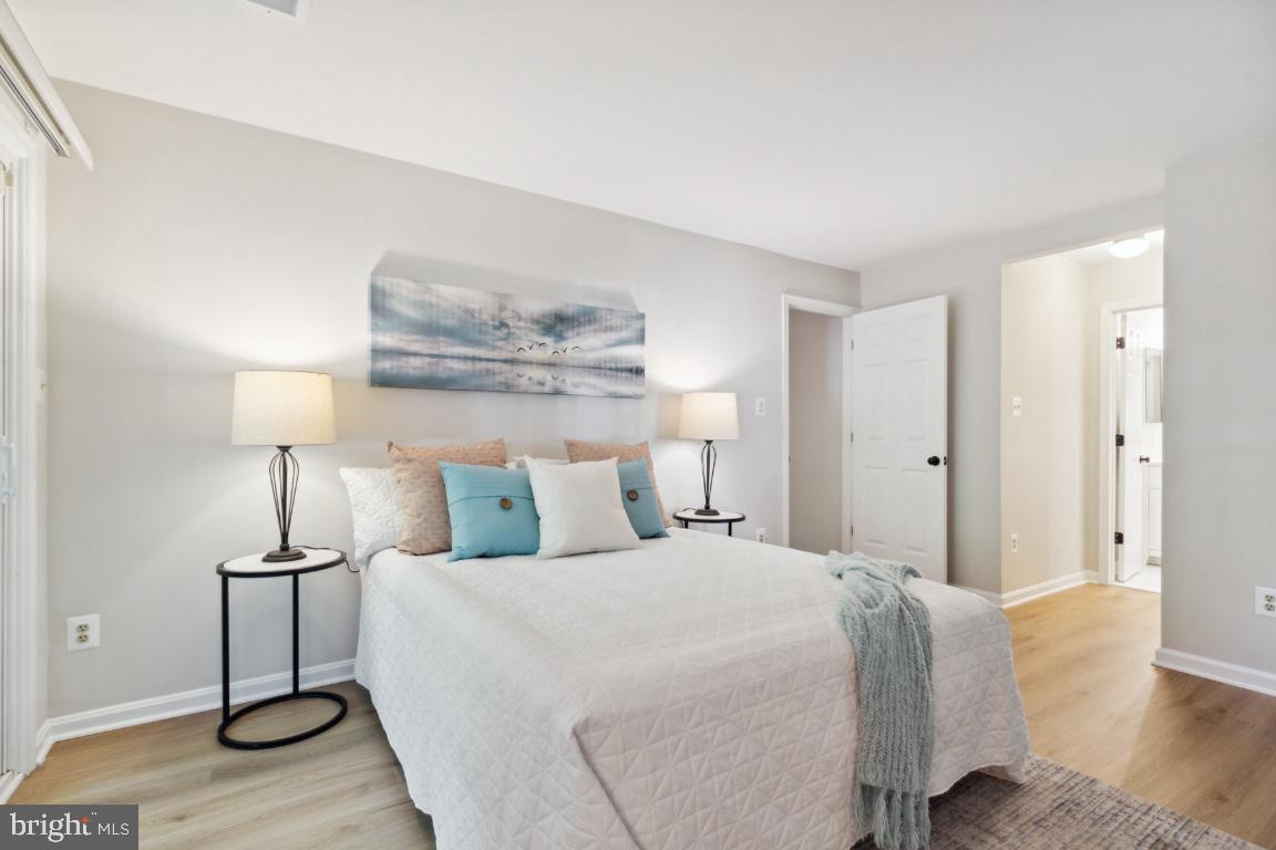 2241 Lovedale Lane, Unit D Reston, VA 20191 - Photo 22 of 31 a bedroom with a bed and wooden floor