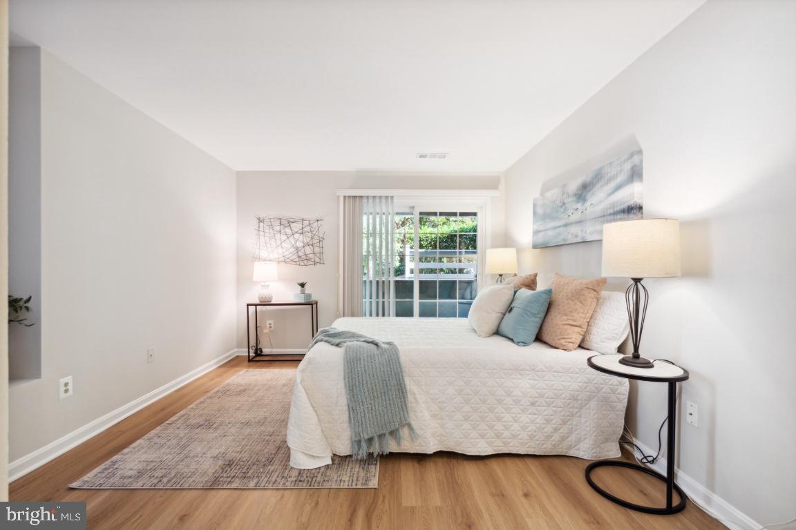 2241 Lovedale Lane, Unit D Reston, VA 20191 - Photo 24 of 31 a bedroom with a bed and wooden floor