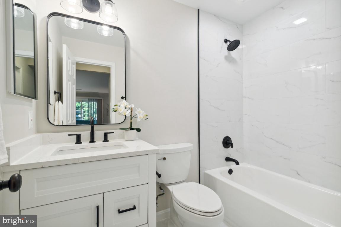2241 Lovedale Lane, Unit D Reston, VA 20191 - Photo 25 of 31 a bathroom with a sink a toilet and a mirror