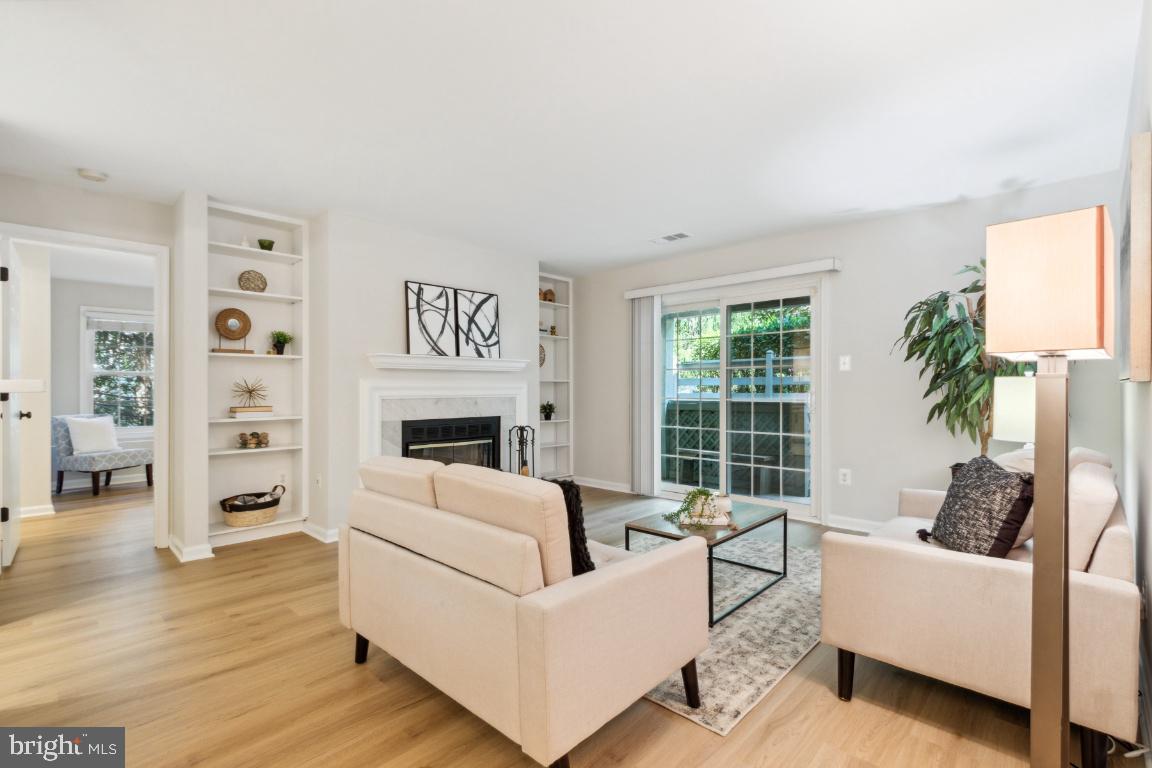 2241 Lovedale Lane, Unit D Reston, VA 20191 - Photo 3 of 31 a living room with furniture a large window and a fireplace