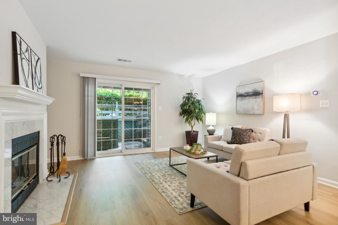 2241 Lovedale Lane, Unit D Reston, VA 20191 - Photo 4 of 31 a living room with furniture and a fireplace