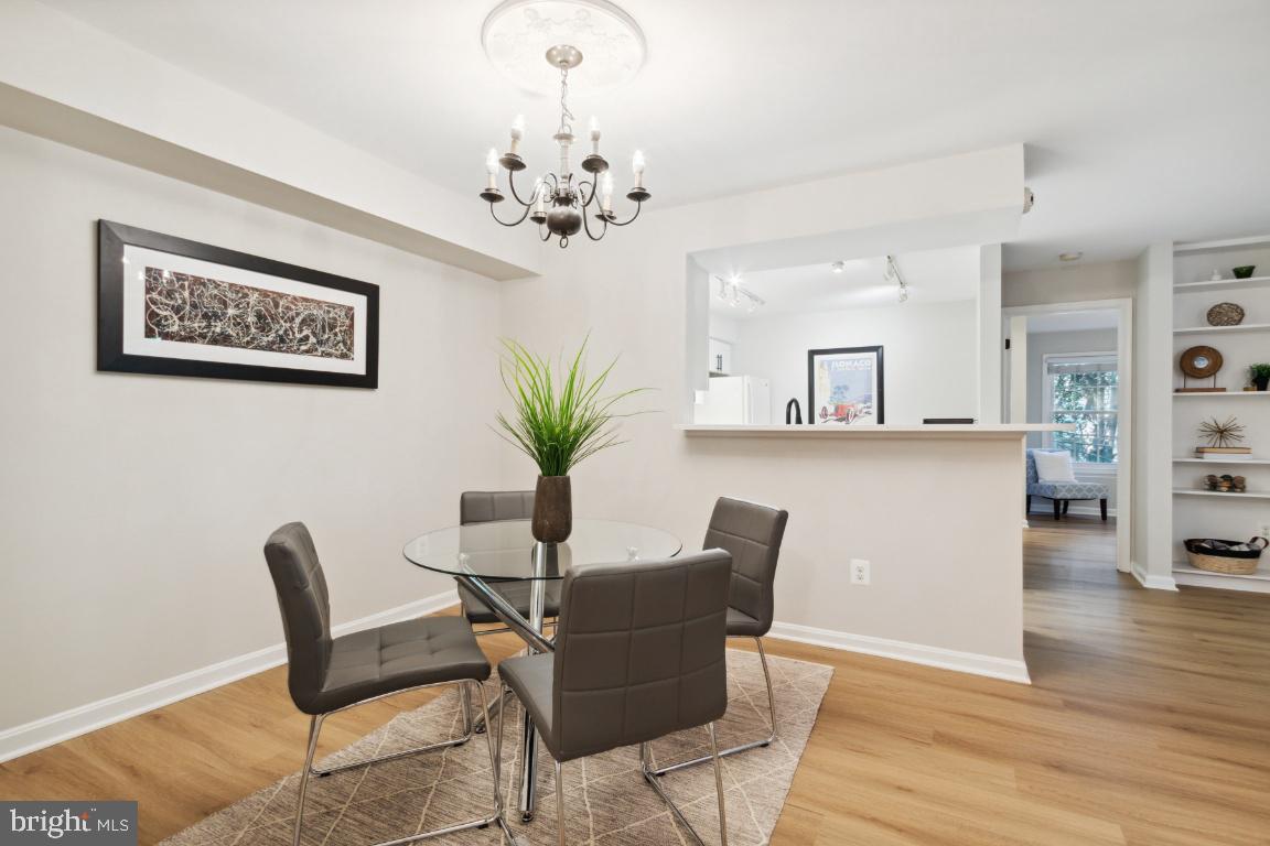 2241 Lovedale Lane, Unit D Reston, VA 20191 - Photo 5 of 31 a view of a dining room with furniture and wooden floor