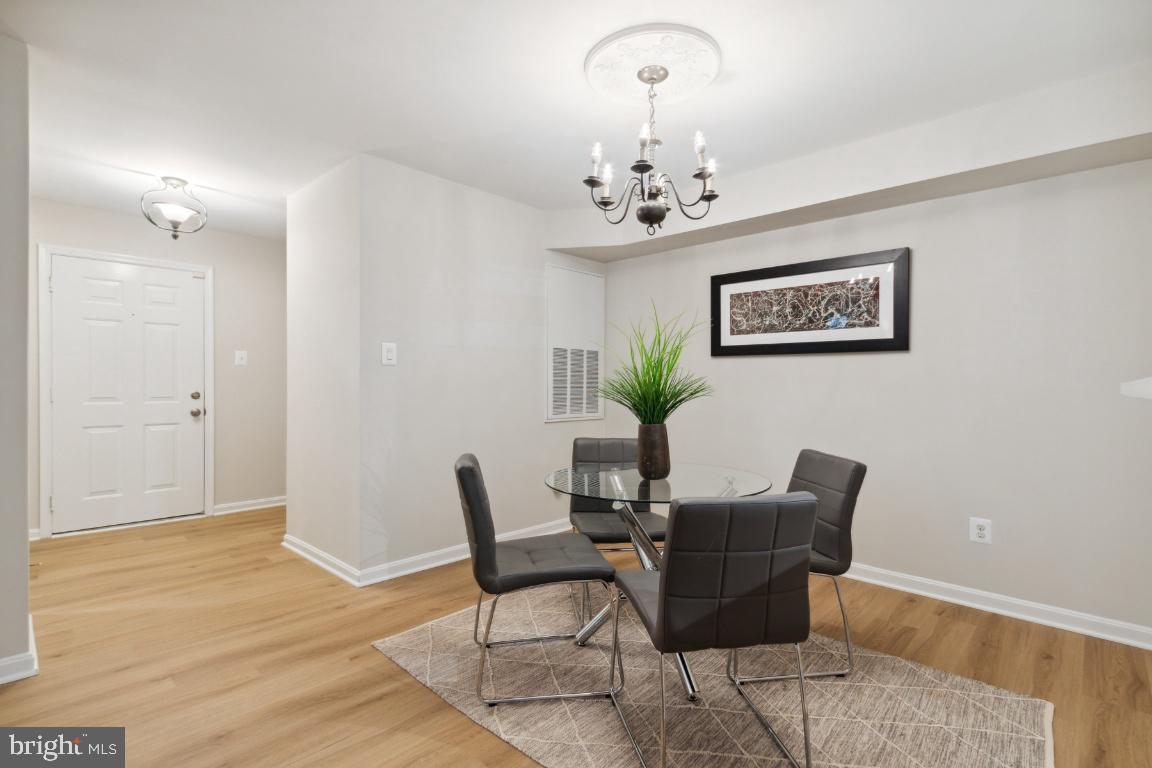 2241 Lovedale Lane, Unit D Reston, VA 20191 - Photo 6 of 31 a view of a dining room with furniture and chandelier