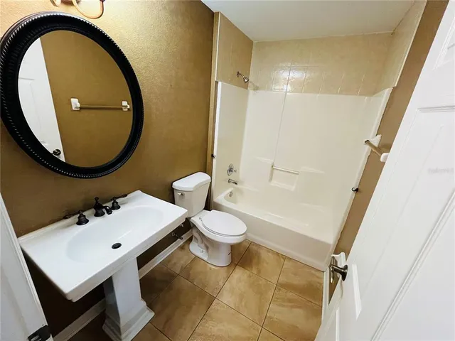 a bathroom with a toilet a sink and a mirror