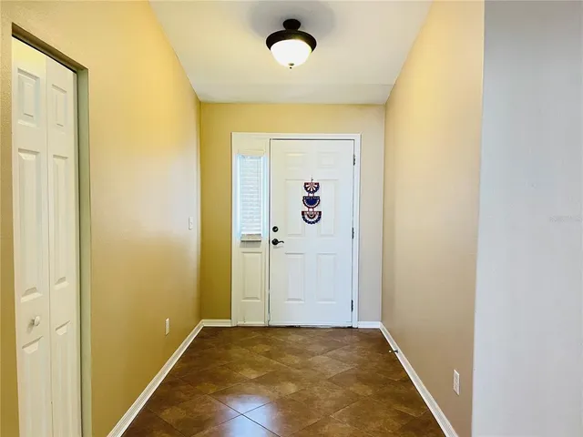 a view of a livingroom with wooden floor and staircase