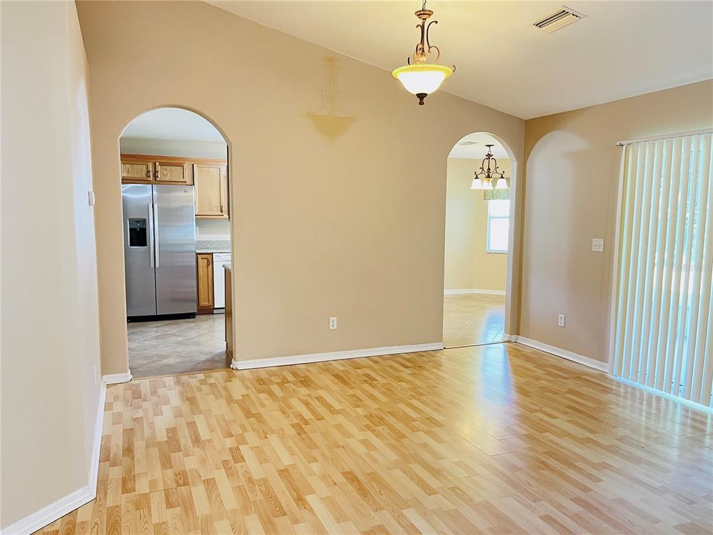 32 Porter Lane Palm Coast, FL 32164 - Photo 6 of 28 a view of empty room with wooden floor and fan