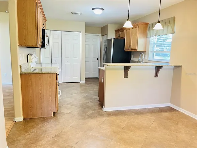 a kitchen with stainless steel appliances granite countertop a refrigerator a sink and dishwasher