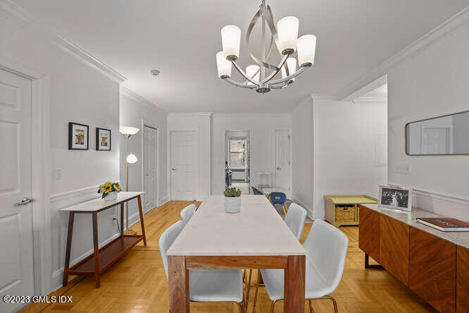 25 West Elm Street, Unit 40 Greenwich, CT 06830 - Photo 11 of 25 a view of a dining room with furniture a chandelier and wooden floor
