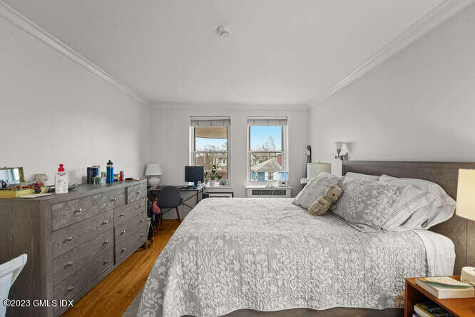 25 West Elm Street, Unit 40 Greenwich, CT 06830 - Photo 14 of 25 a bedroom with a bed and wooden floor