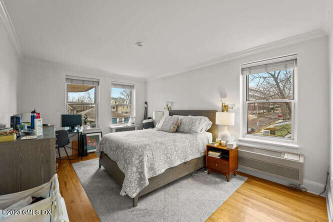 25 West Elm Street, Unit 40 Greenwich, CT 06830 - Photo 15 of 25 a bedroom with a bed and a dresser next to a window