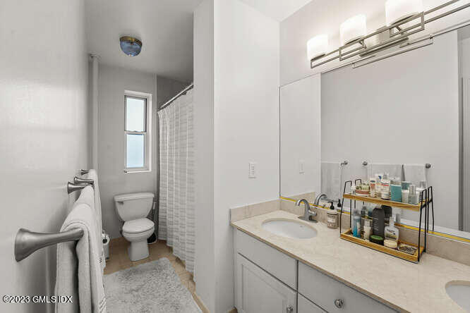 25 West Elm Street, Unit 40 Greenwich, CT 06830 - Photo 17 of 25 a bathroom with a sink toilet and shower