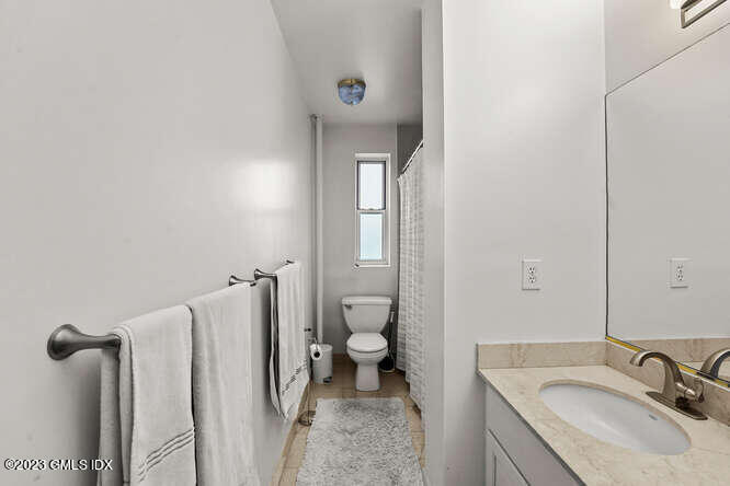 25 West Elm Street, Unit 40 Greenwich, CT 06830 - Photo 18 of 25 a bathroom with a sink toilet and shower