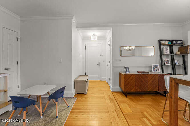 25 West Elm Street, Unit 40 Greenwich, CT 06830 - Photo 9 of 25 a spacious bedroom with a bed and table chair