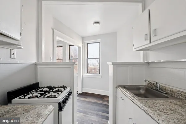 a kitchen with a sink stove and cabinets
