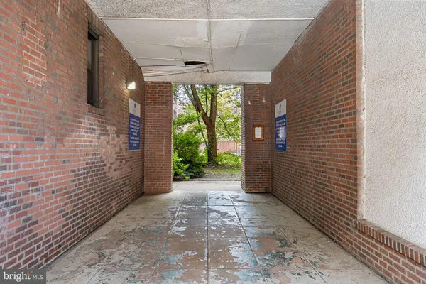 a view of a hallway with brick walls
