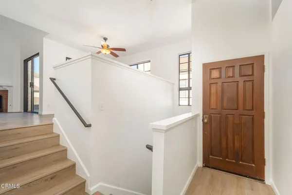 a view of entryway and hall with wooden floor