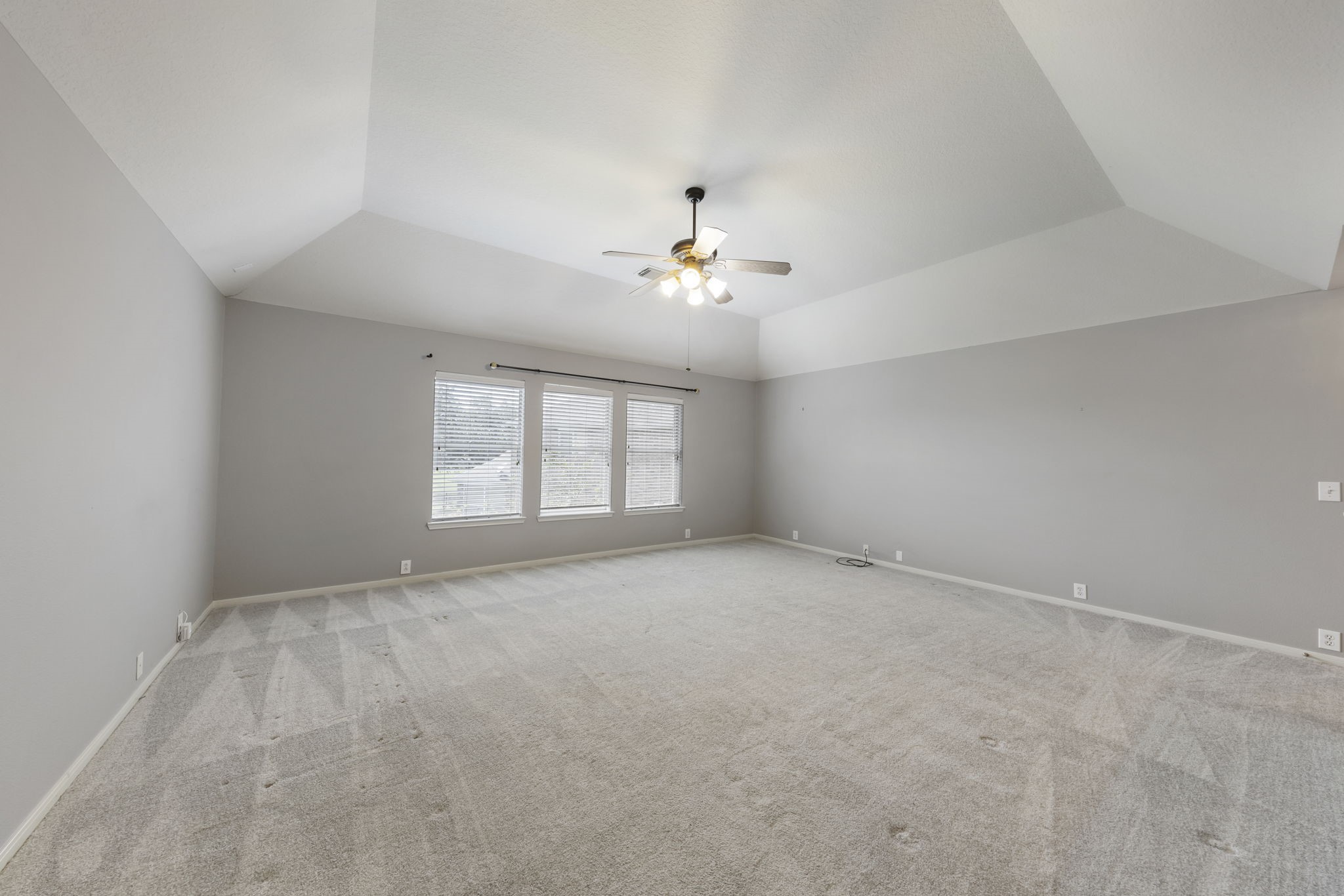 2907 Stemwood Drive Spring, TX 77388 - Photo 20 of 33 Oversized upstairs game room with vaulted ceilings, plush carpeting, and an expansive open layout perfect for a media room, playroom, or additional living space.