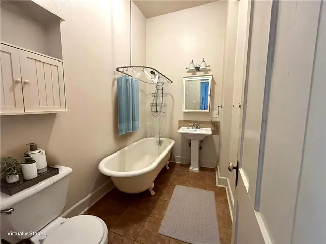 a bathroom with a toilet sink and mirror
