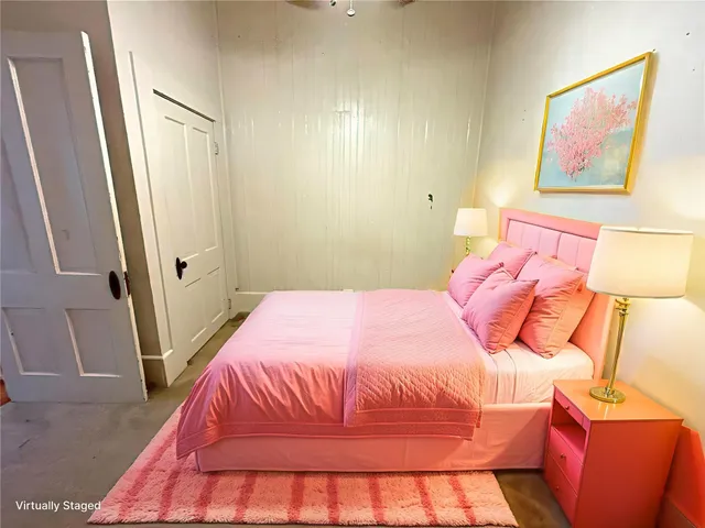 a bedroom with a bed and a mirror