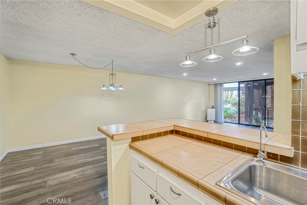 8650 Gulana Avenue Playa del Rey, CA 90293 - Photo 13 of 46 a view of a kitchen with a sink and chandelier