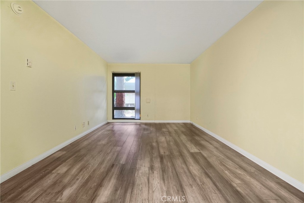 8650 Gulana Avenue Playa del Rey, CA 90293 - Photo 15 of 46 an empty room with wooden floor and windows