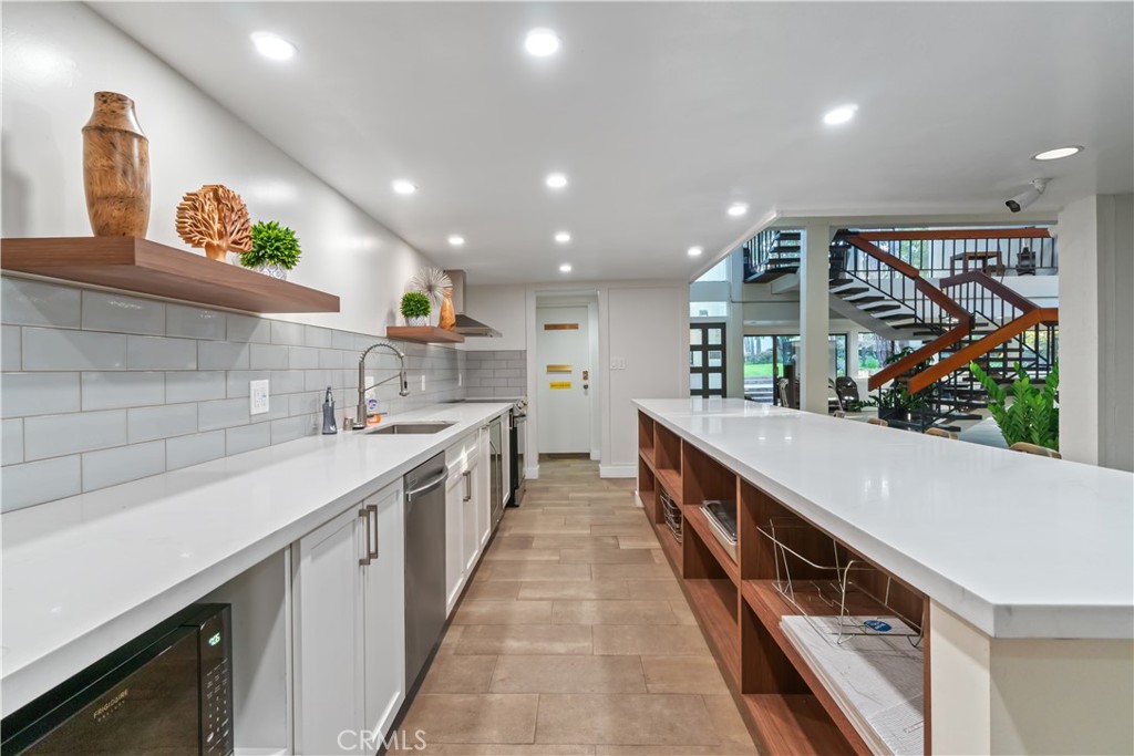8650 Gulana Avenue Playa del Rey, CA 90293 - Photo 39 of 46 a large kitchen with stainless steel appliances a sink and cabinets