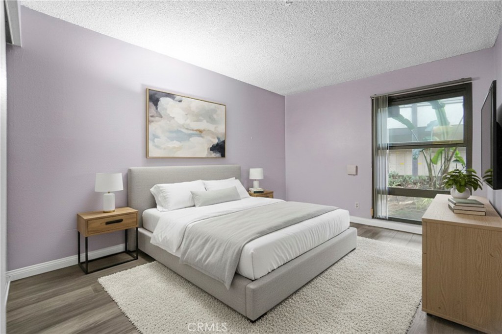 8650 Gulana Avenue Playa del Rey, CA 90293 - Photo 4 of 46 a bedroom with a large bed and a large window