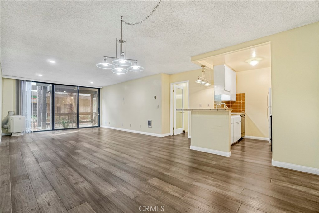 8650 Gulana Avenue Playa del Rey, CA 90293 - Photo 6 of 46 a view of a kitchen with wooden floor and a large window
