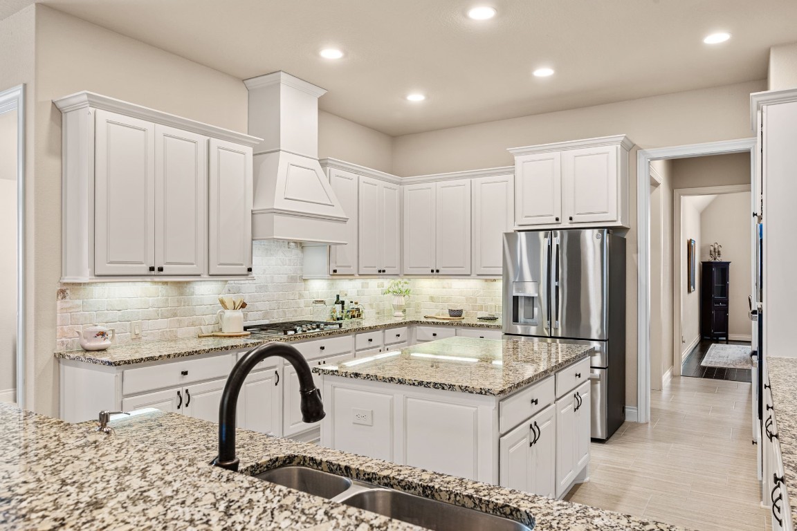 1607 Dove Ridge Drive Katy, TX 77493 - Photo 2 of 38 The chef-inspired kitchen features generous prep space, abundant cabinetry, and a premium GE Profile appliance suite with a five-burner cooktop, 30-inch double ovens, and an ultra-quiet dishwasher.