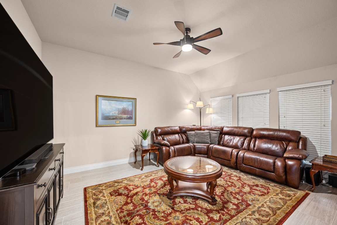 1607 Dove Ridge Drive Katy, TX 77493 - Photo 22 of 38 a living room with furniture a rug and a flat screen tv
