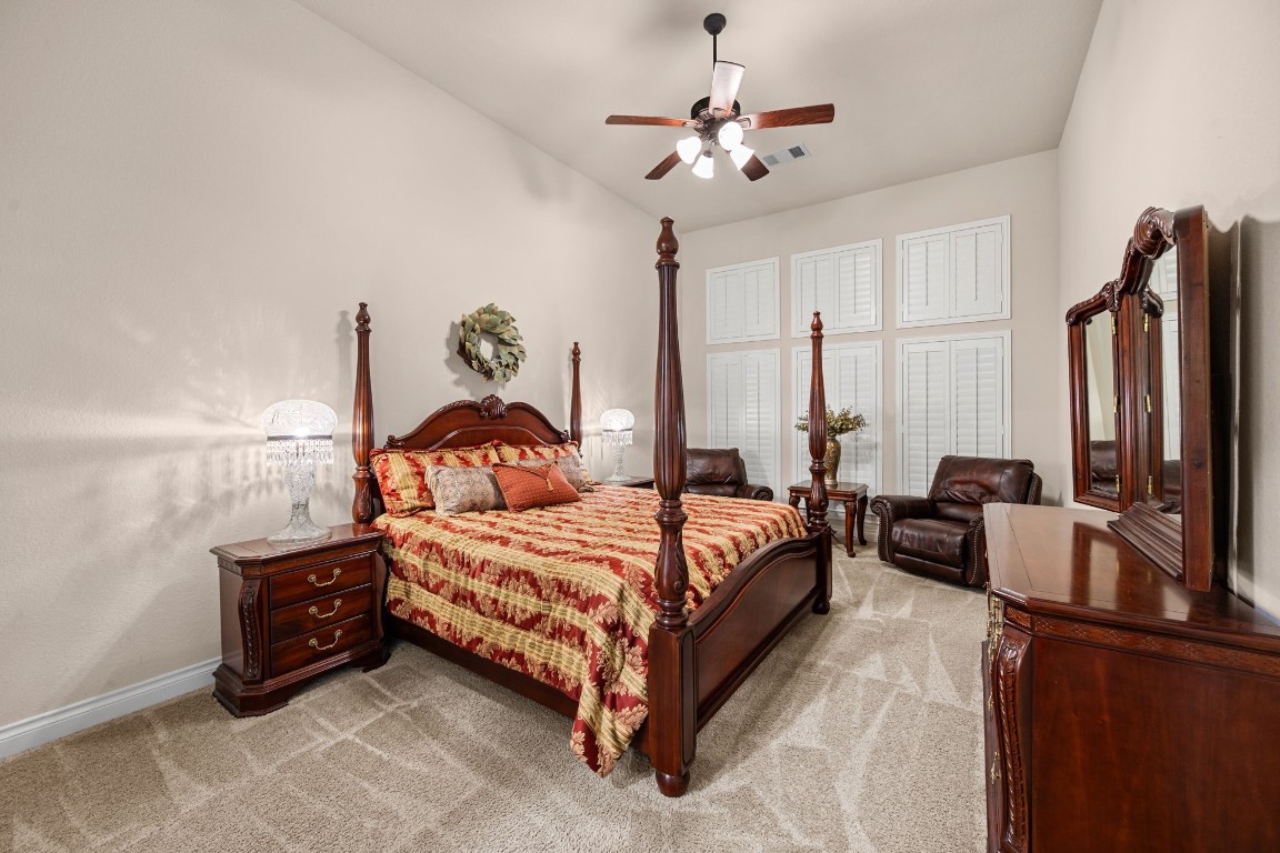 1607 Dove Ridge Drive Katy, TX 77493 - Photo 23 of 38 a spacious bedroom with a bed and a chandelier