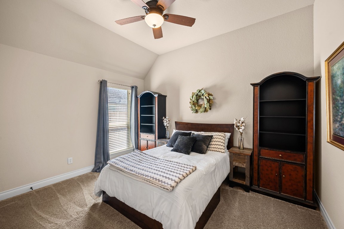 1607 Dove Ridge Drive Katy, TX 77493 - Photo 29 of 38 a bedroom with a bed and a ceiling fan