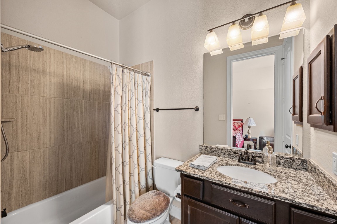 1607 Dove Ridge Drive Katy, TX 77493 - Photo 33 of 38 a bathroom with a granite countertop sink and a mirror