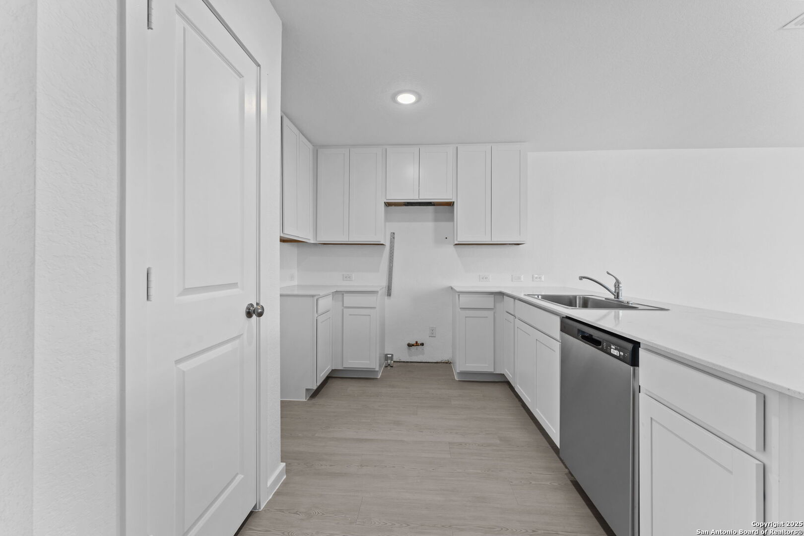 2067 Powell Place Converse, TX 78109 - Photo 11 of 22 a kitchen with granite countertop white cabinets and white stainless steel appliances