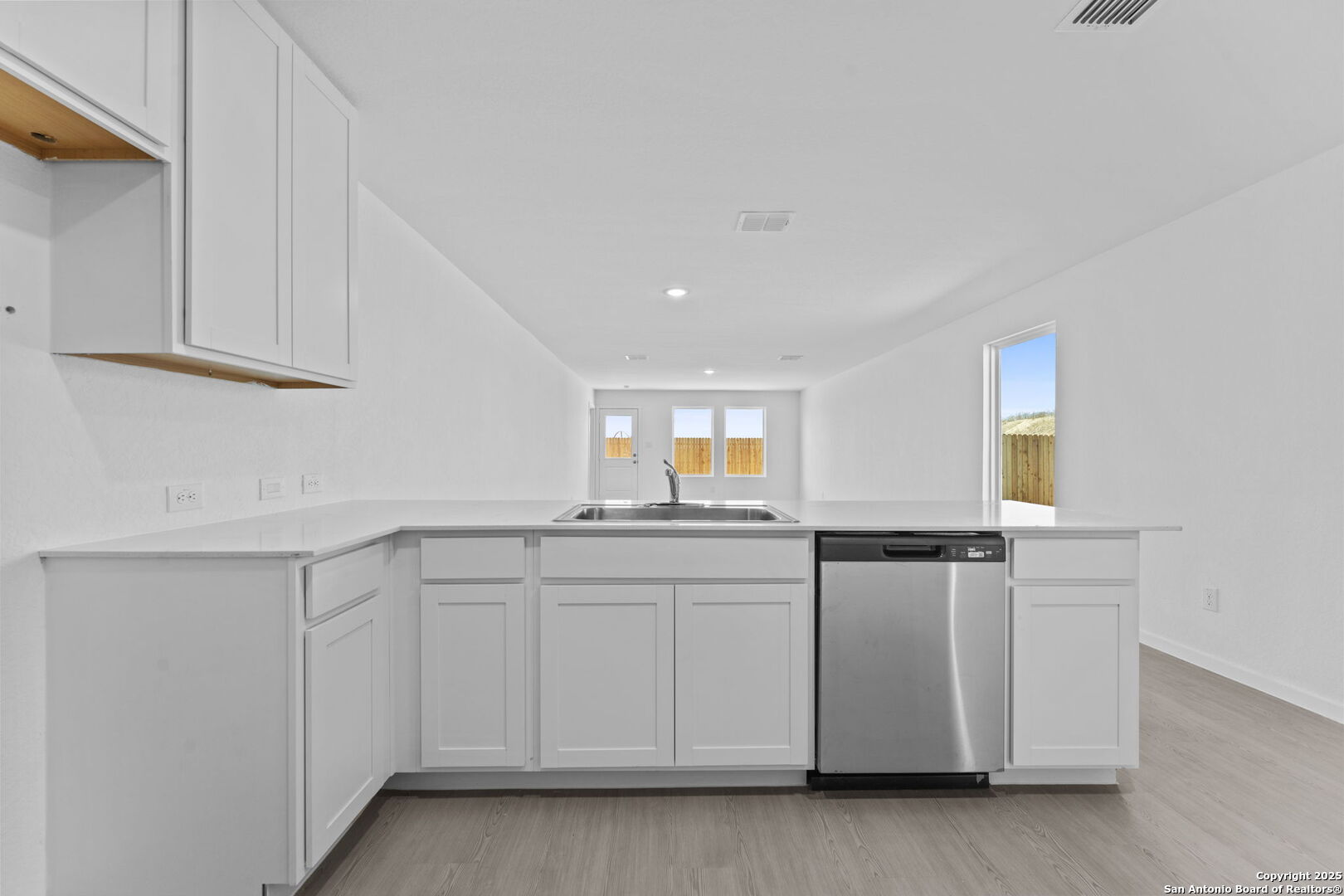 2067 Powell Place Converse, TX 78109 - Photo 12 of 22 a kitchen with granite countertop white cabinets and white appliances