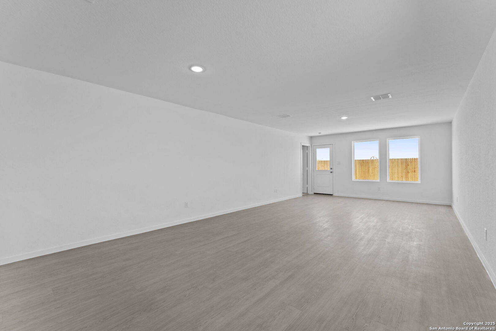 2067 Powell Place Converse, TX 78109 - Photo 13 of 22 a view of an empty room with a window and wooden floor