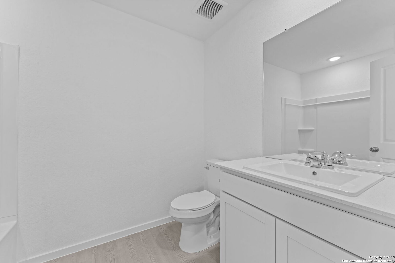 2067 Powell Place Converse, TX 78109 - Photo 4 of 22 a bathroom with a sink a toilet and a mirror