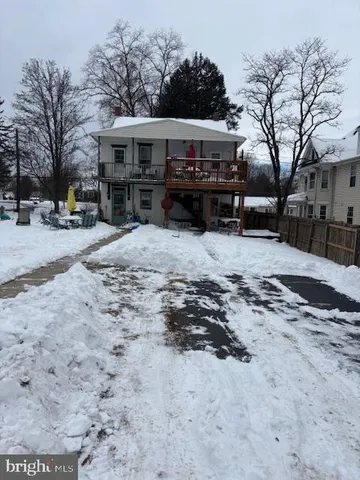 a view of a house with a snow in the yard
