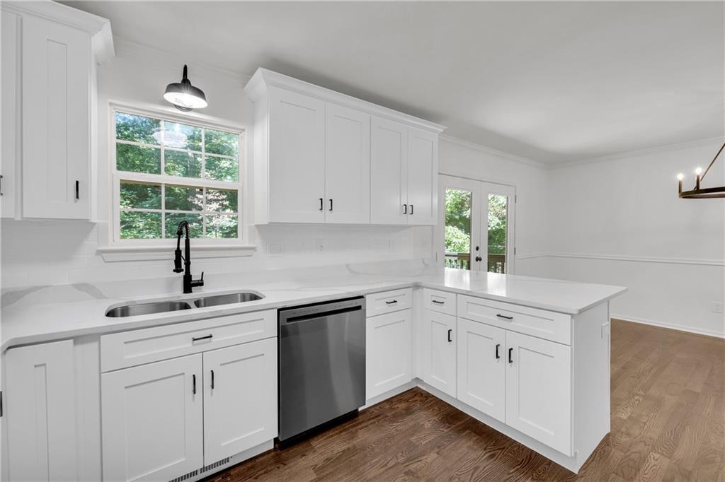 2941 Lake Hollow Road Gainesville, GA 30501 - Photo 17 of 53 a kitchen with white cabinets appliances a sink and a window
