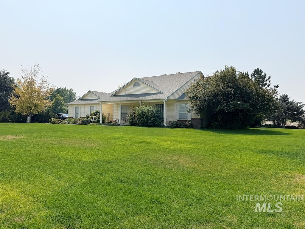 5875 Diamond Ridge Way Nampa, ID 83686 - Photo 2 of 32 Charming single-story residence featuring a covered front porch, gabled roofline, and neutral exterior finishes